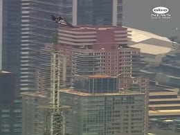 Two Climbers Scale Empire State Building Spire