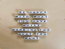 Motivational Quote About Gratitude and Ambition in Letter Tiles