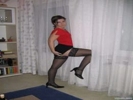 Gorgeous wife getting a little nasty for the camera wearing her silky black stockings with a short skirt and heels