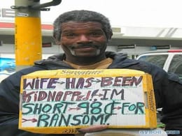 Man Holds Sign Claiming Wife Was Kidnapped and Needs Money