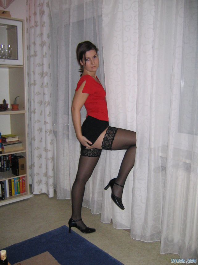 Gorgeous wife getting a little nasty for the camera wearing her silky black stockings with a short skirt and heels