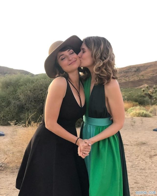 Milana Vayntrub gets kiss from another woman.
