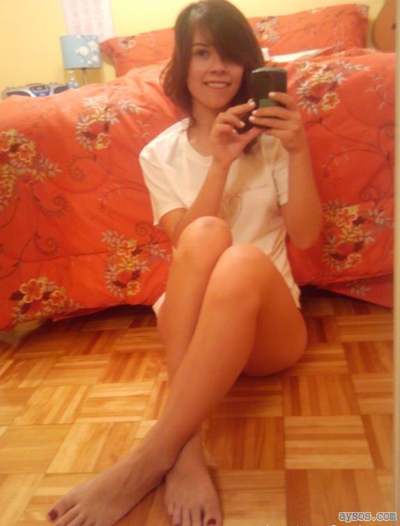 Cute lady taking a sexy selfie in only a shirt