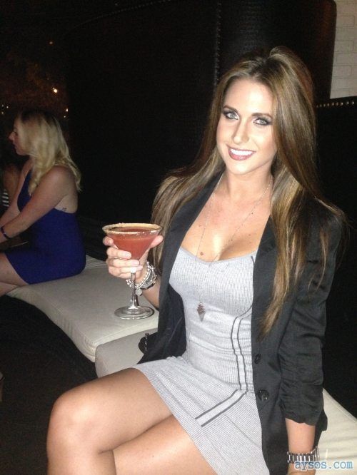 Pretty babe enjoying a drink in her sexy little dress