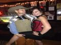 Cute bar maid flirts with a cowboy customer