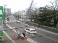 Man Holds up street pole