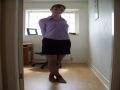 A very cute wife showing off her sexy body in a short skirt and black pantyhose for the camera