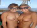 Cute babes go topless on a boat